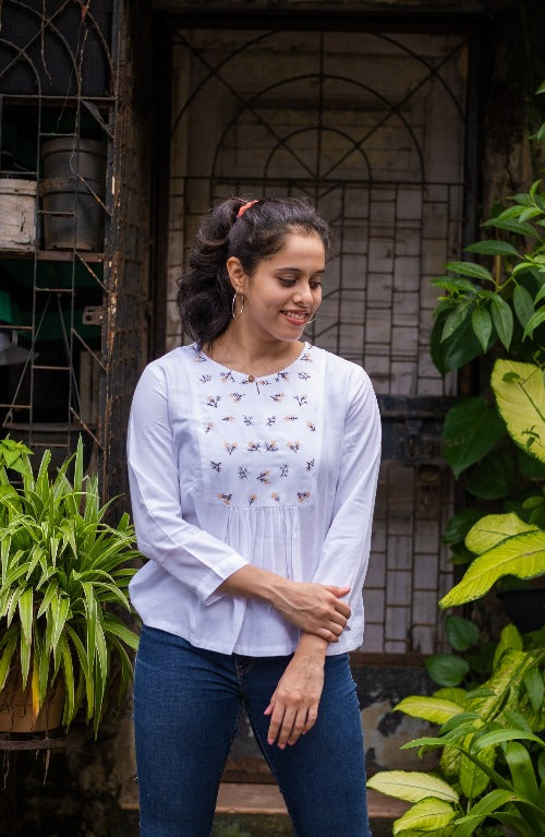 White Embroidered Peplum Top in Lyocell fabric by Earthy Route, a sustainable clothing brand. The fabric is breatheable and summer friendly. This product has freeshipping.